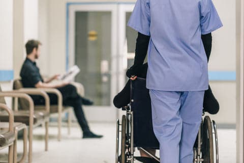 Nurse pushing wheelchair